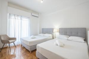 A bed or beds in a room at Athens Dreams & Suites Apartments