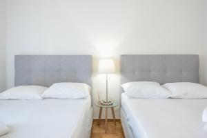 A bed or beds in a room at Athens Dreams & Suites Apartments