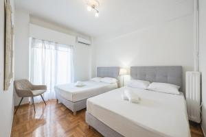 A bed or beds in a room at Athens Dreams & Suites Apartments