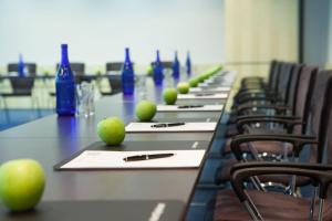 a long table with chairs and apples on it at IntercityHotel Wien in Vienna