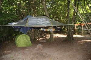 a tent is set up in the woods at River Tribe Experience Camp in Laino Borgo +4 photos