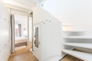 a room with white walls and stairs and a bedroom at Townhouse Calatrava in Palma de Mallorca