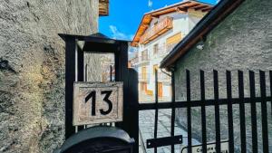a door with the number on it next to a building at Appartamento Treize - Affitti Brevi Italia in Bardonecchia