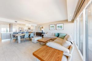 a living room with a couch and a table at Ocean Vista #1004 in South Padre Island