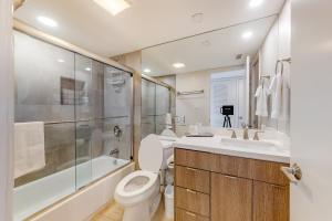 a bathroom with a toilet and a shower and a sink at Ocean Vista #1004 in South Padre Island +18 photos