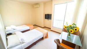 Ένα ή περισσότερα κρεβάτια σε δωμάτιο στο Hotel Santorini Resort