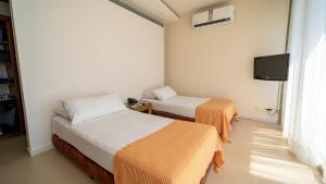 Ένα ή περισσότερα κρεβάτια σε δωμάτιο στο Hotel Santorini Resort