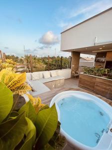 a bath tub sitting on top of a house at Apê Jardins in Flecheiras +37 photos