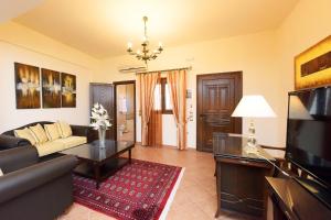 a living room with a couch and a table at Paris Hotel in Rhodes Town