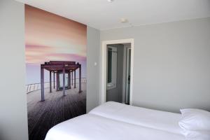 Ein Bett oder Betten in einem Zimmer der Unterkunft Hotel Andante aan Zee