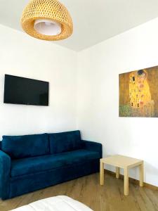 a living room with a blue couch and a table at Villa Francesca in Spoltore