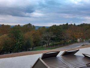 a wooden bench sitting on top of a park at La grande Maison in Donzenac +10 photos