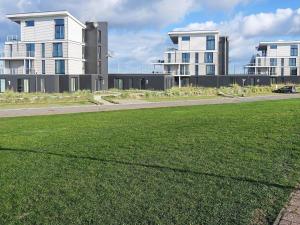 a field of grass in front of some buildings at 8 person holiday home in Wendtorf in Wendtorf