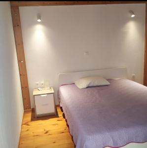 a bedroom with a bed and a side table at M.J.P. House in Metamorfosi