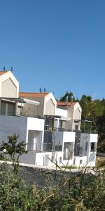 a row of white houses with balconies on them at M.J.P. House in Metamorfosi