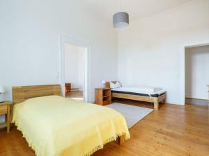 a bedroom with a yellow bed and a bench at Apartment in Gerbstedt Friedeburg with Terrace in Friedeburg