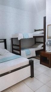 Cama ou camas em um quarto em Pousada Aquarela
