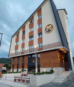 a hotel building with a masy sign on it at Modern Mountain luxury in Kolašin