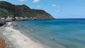 a view of a beach with people in the water at Alo Baía São Lourenço in Santa Bárbara