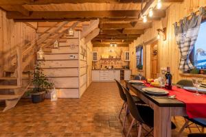 a kitchen and dining room with a table in a barn at Domki na Kamiennej Laworcie 789410422 in Ustrzyki Dolne