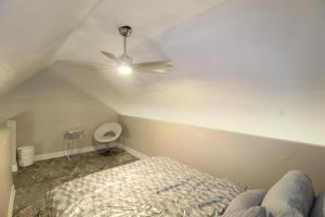 a bedroom with a ceiling fan and a bed at Modern Tiny House Experience in Stone Mountain