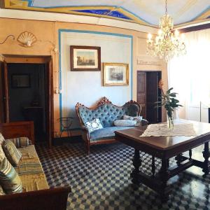 a living room with a couch and a table at AGRITURISMO CASA OLIVIERI in Sestri Levante