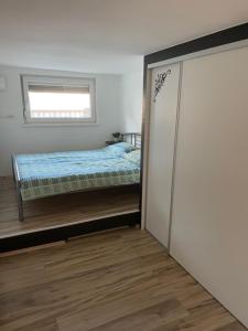 a bedroom with a bed and a closet with a door at Cute Spot in Ljubljana in Ljubljana