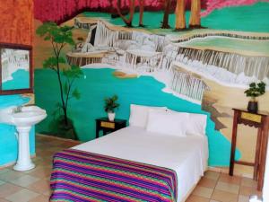 a bedroom with a bed and a painting on the wall at HOTEL ESMERALDA in Tampico +63 photos