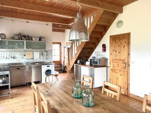 a kitchen with a wooden table and a dining room at Authentisches Inselhaus - ideal für Kiter/Surfer/Familien in Fehmarn