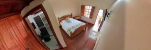 an overhead view of a bedroom with a table and a window at La Casa de las Flores Hostal in Jardin