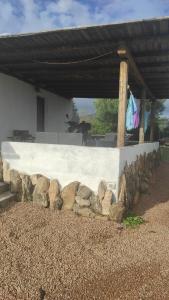 a stone wall with a bunch of rocks around it at Studio flat in Golfo Aranci