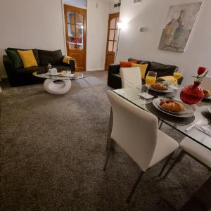 a living room with a table with food on it at PREMIER - Whifflet Apartment in Coatbridge