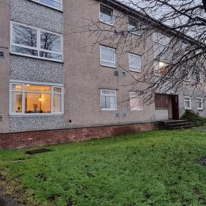 a large brick building with a yard in front of it at PREMIER - Whifflet Apartment in Coatbridge