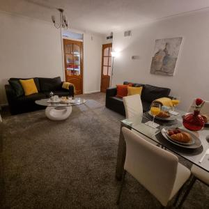 a living room with a couch and a table at PREMIER - Whifflet Apartment in Coatbridge