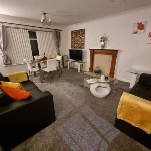 a living room with a couch and a table at PREMIER - Whifflet Apartment in Coatbridge
