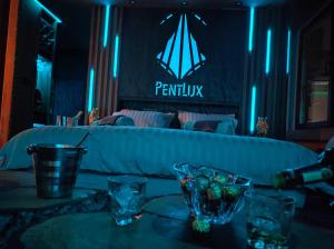 a table with glasses and a couch in a room at PentLux - SPA Penthouse in the heart of Skopje in Skopje