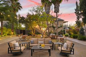a patio with tables and chairs and a house at Bungalows 313 in Sonoma