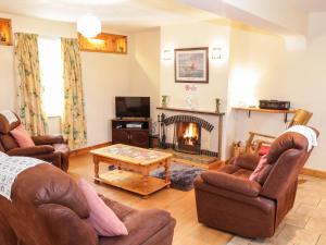 a living room with two couches and a fireplace at At the Crossroads in Louisburgh