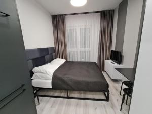 Llit o llits en una habitació de Villa Nova Apartamenty