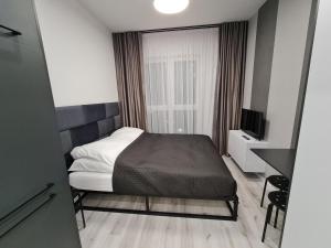 Ένα ή περισσότερα κρεβάτια σε δωμάτιο στο Villa Nova Apartamenty