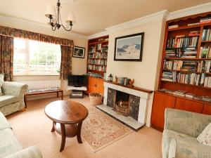 a living room with a fireplace and book shelves at The Lodge in Beaufort