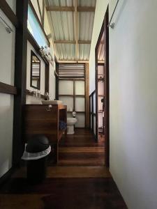 a hallway of a bathroom with a sink and a toilet at Pequeño Paraiso 2 in Punta Uva