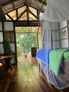 a bedroom with a bed with a mosquito net at Pequeño Paraiso 2 in Punta Uva