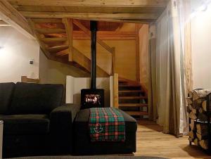 a living room with a couch and a fireplace at Maison Cluaran in Vénosc