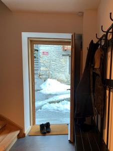 a door leading into a room with snow outside at Maison Cluaran in Vénosc