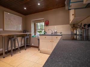 a kitchen with a sink and a counter top at Rottal Bothy in Millton of Clova