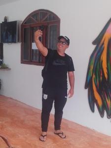 a man standing in a room with a window at Hostel e Pousada Boa Vista in Joinville