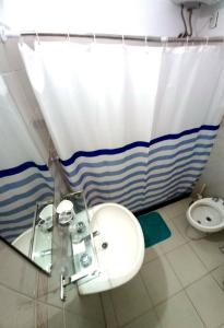 a bathroom with a sink and a toilet at Apartamento Piriápolis in Piriápolis