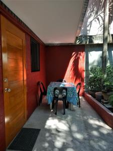 a patio with a table and chairs and a door at Felipa Beach Residence - Ilang Ilang in Dumaguete