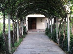 an archway with trees in front of a building at La Casona de Don Salo in Mendoza